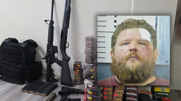 A photo of rifles, ammunition, and a tactical vest on a table, with an inset mugshot of a bearded man with a bandaged forehead.