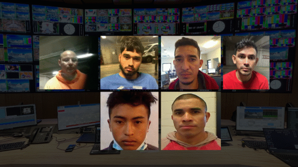 A collage of six men's mugshots is overlaid on a background of a control room with multiple monitors and equipment.